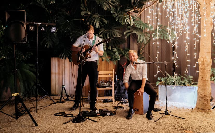 Outdoor wedding performance with string lights